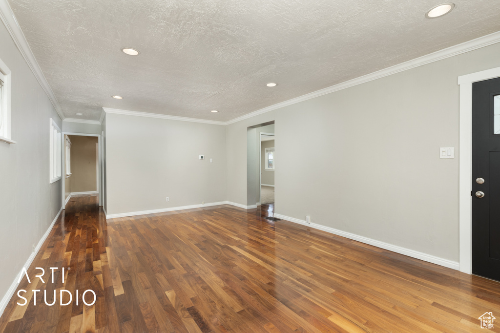 Unfurnished living room featuring recessed lighting, baseboards, and wood finished floors