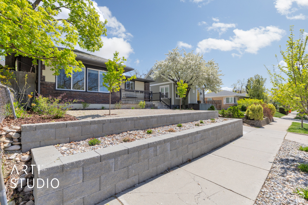 View of property exterior featuring brick siding and fence
