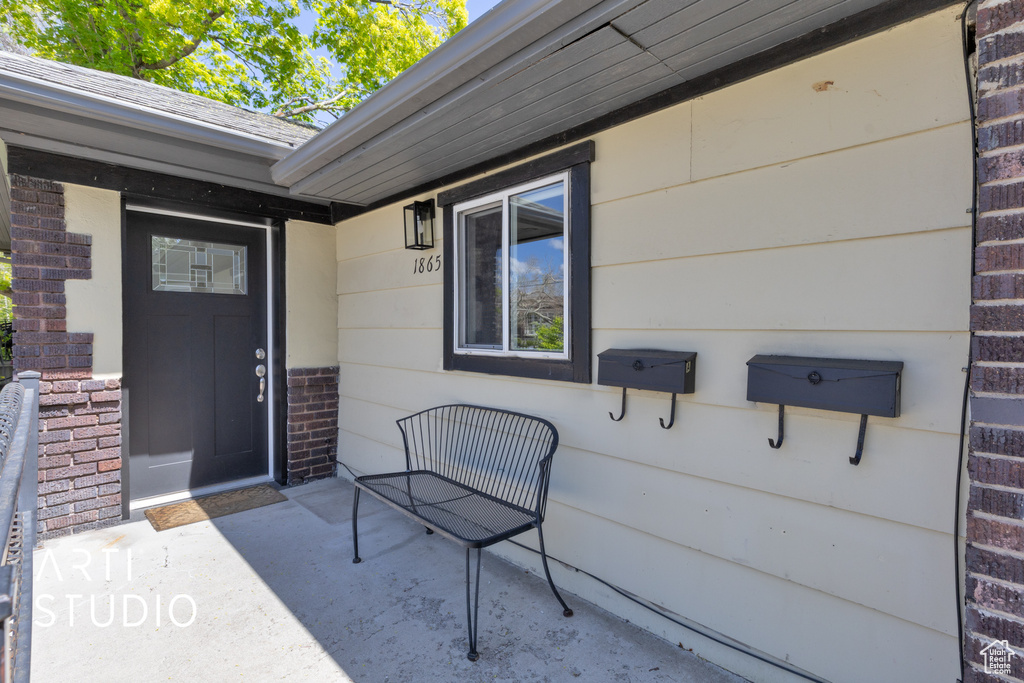View of exterior entry featuring brick siding