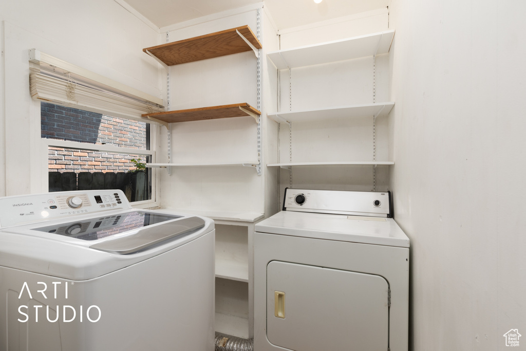 Laundry area featuring washing machine and clothes dryer and laundry area