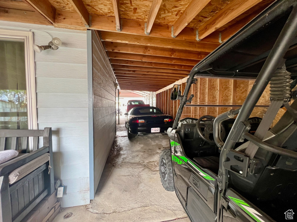 View of vehicle parking featuring a carport