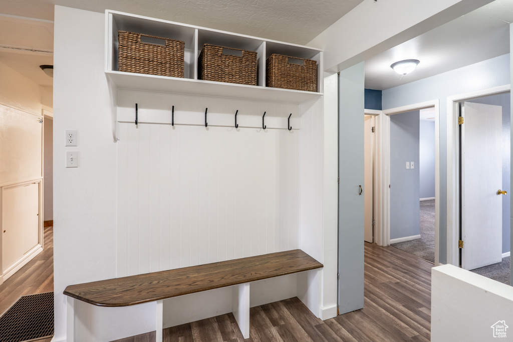 Mudroom featuring baseboards and wood finished floors