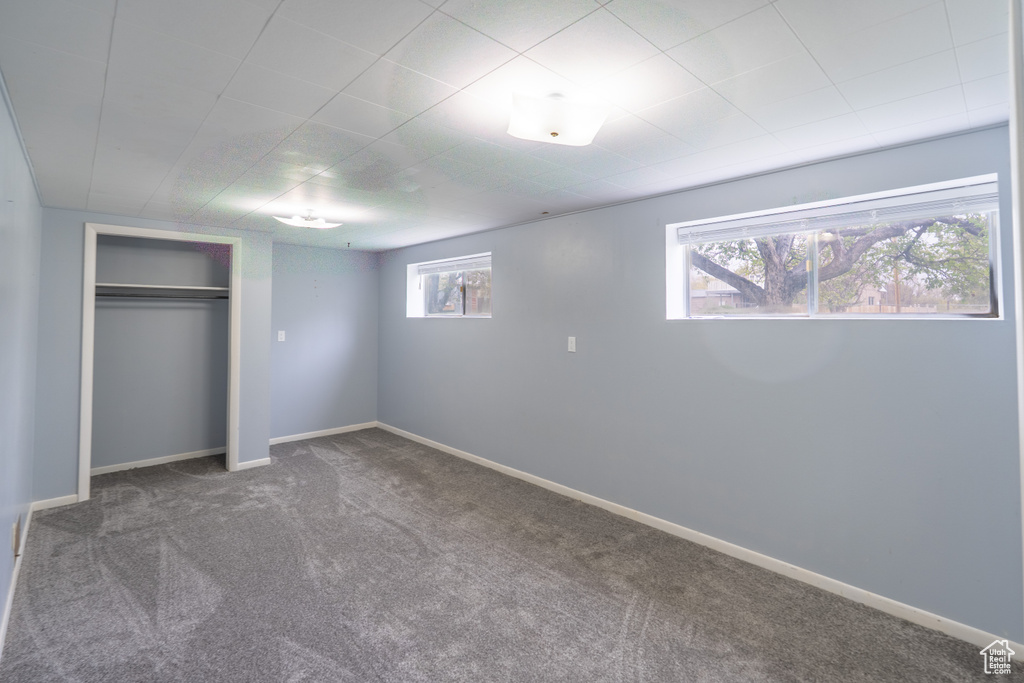 Unfurnished bedroom featuring carpet flooring, a closet, and baseboards