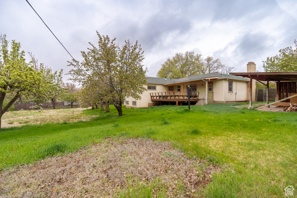 View of yard featuring a deck and fence