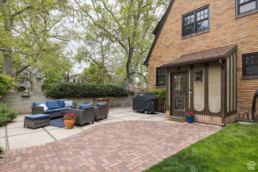 View of patio featuring grilling area, fence, and outdoor lounge area