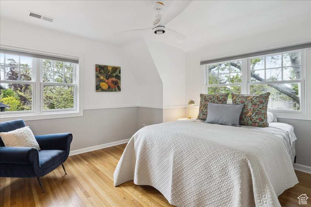 Bedroom featuring visible vents, wood finished floors, baseboards, and ceiling fan