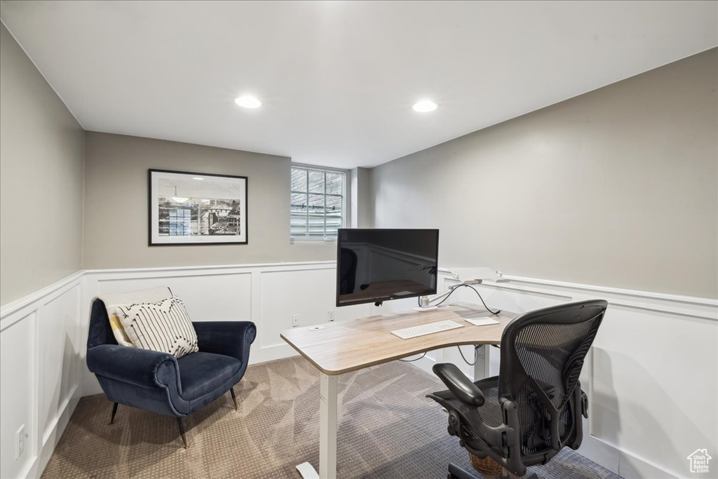 Home office featuring carpet flooring, a decorative wall, recessed lighting, and wainscoting