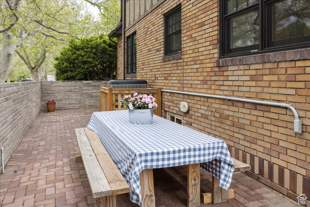 View of patio with area for grilling and fence