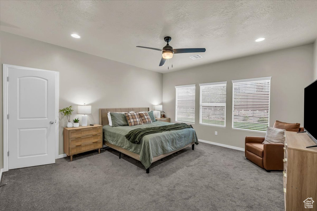 Bedroom featuring baseboards, ceiling fan, visible vents, and carpet floors