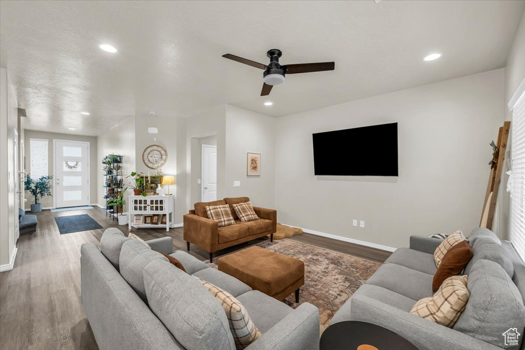 Living area featuring ceiling fan, recessed lighting, baseboards, and wood finished floors
