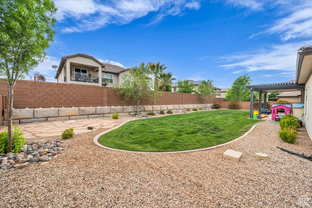 View of yard featuring a patio and a fenced backyard
