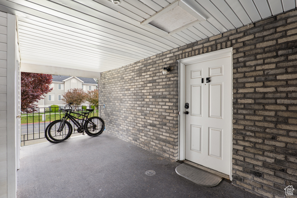 Property entrance featuring brick siding