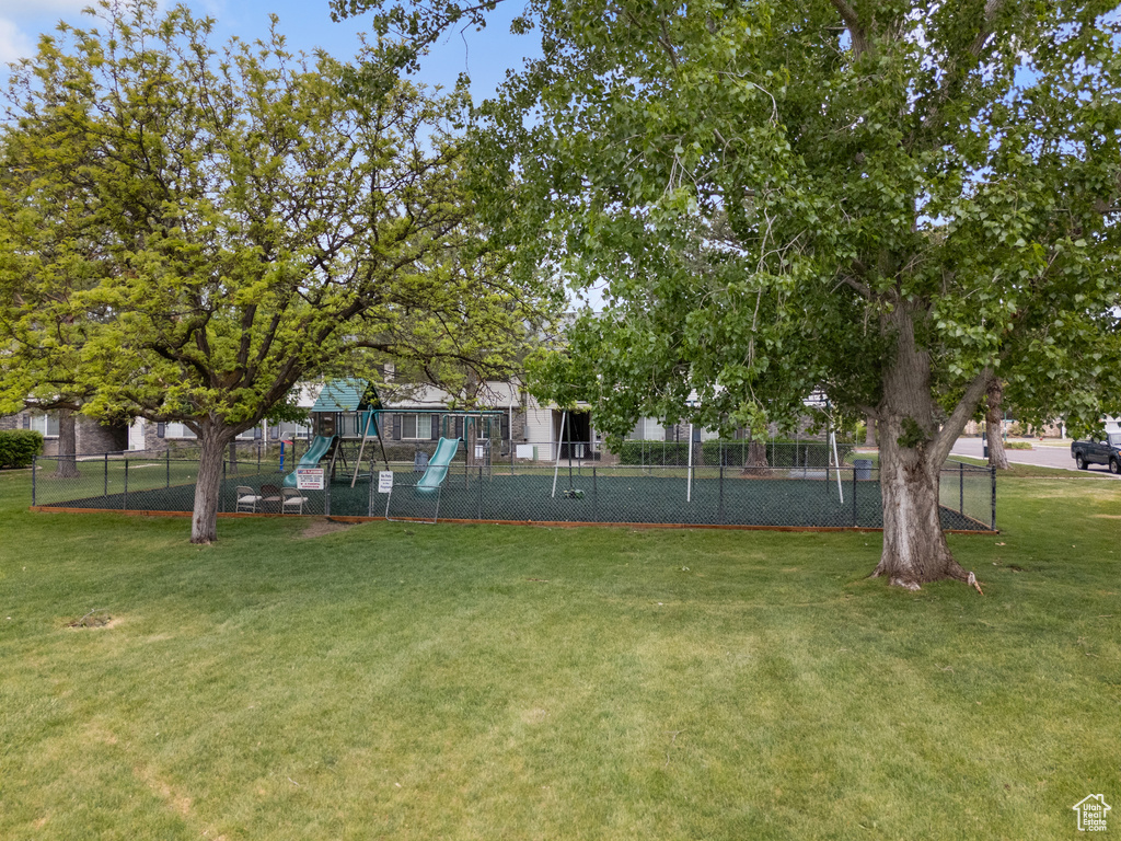 View of yard with playground community and fence