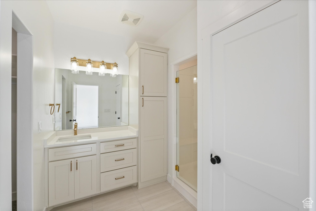 Full bath with vanity, a shower stall, visible vents, and tile patterned floors