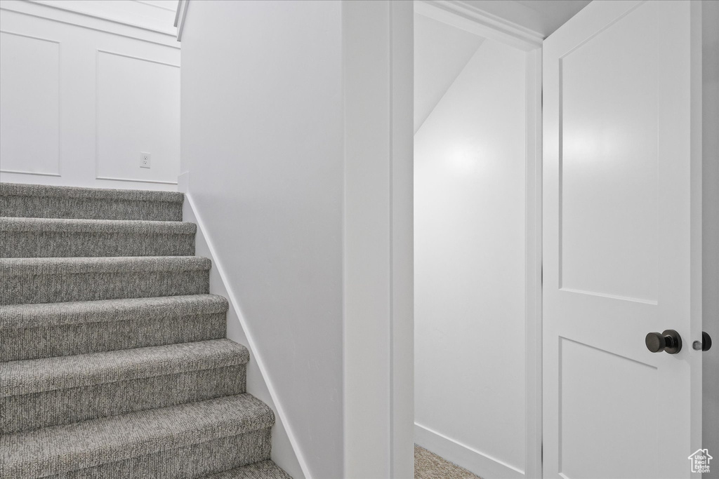 Staircase featuring carpet floors and baseboards