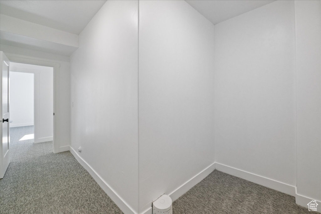 Hallway featuring baseboards and carpet floors