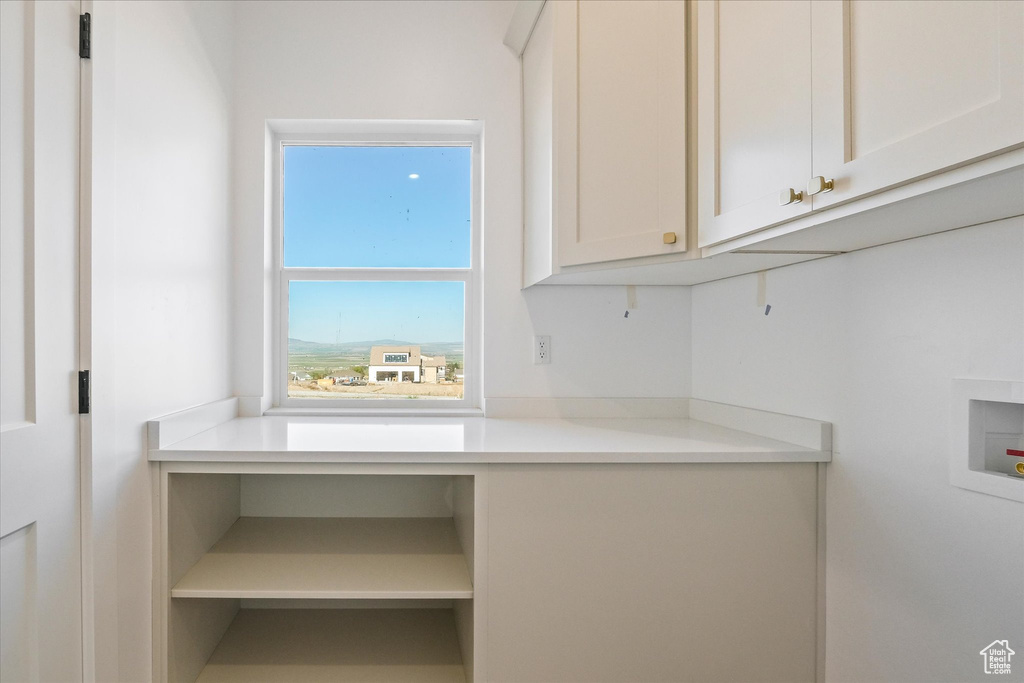 Washroom with cabinet space and washer hookup