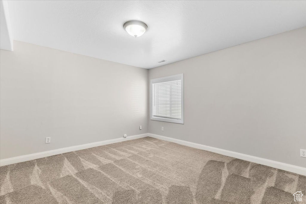 Unfurnished room featuring baseboards and carpet floors