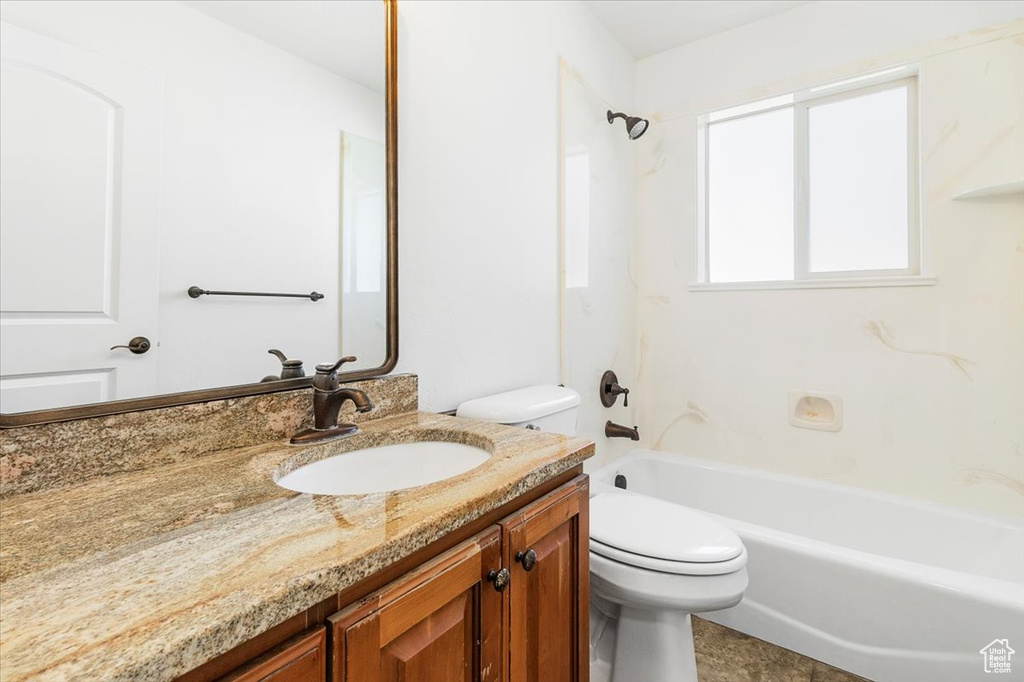 Bathroom with vanity, toilet, and tub / shower combination