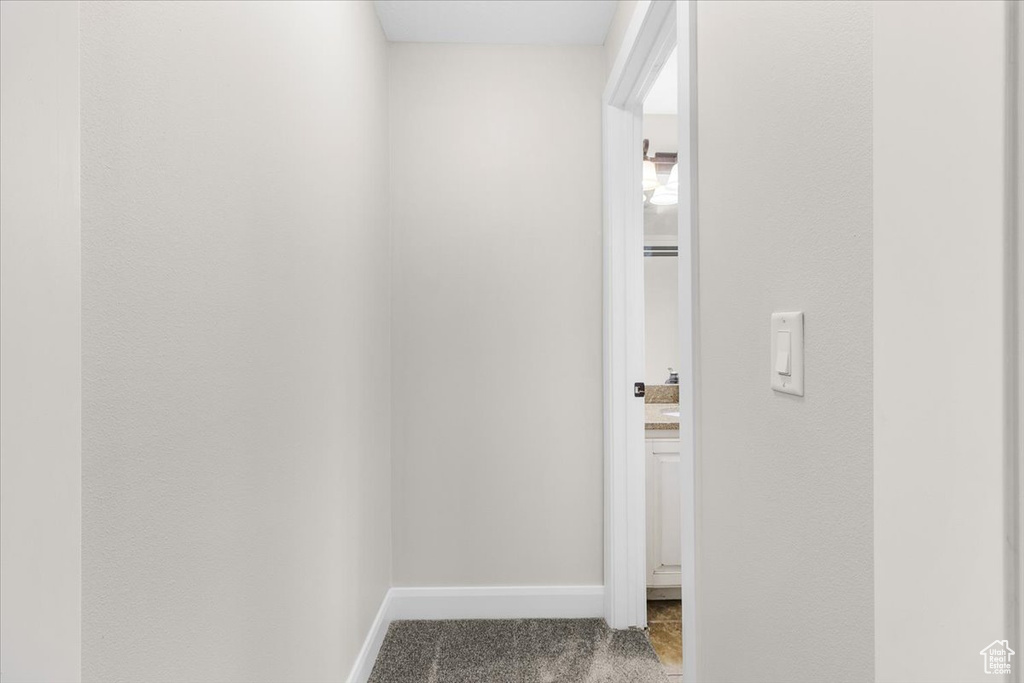 Hall with carpet and baseboards