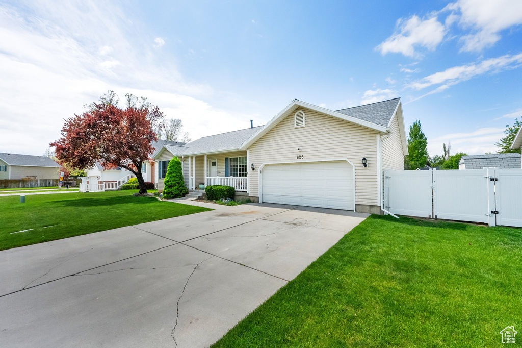 Ranch-style house featuring fence, a garage, concrete driveway, a porch, and a gate