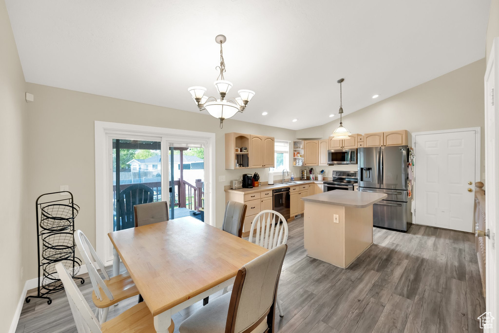 Dining room with lofted ceiling, recessed lighting, a chandelier, light wood-style flooring, and baseboards