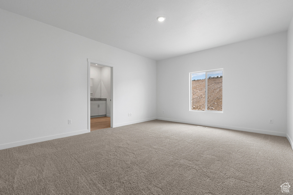 Spare room featuring recessed lighting, baseboards, and carpet floors