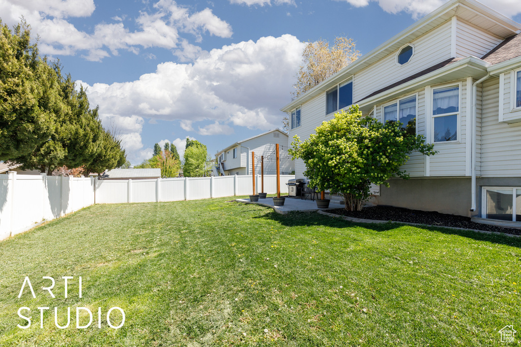 View of yard featuring a fenced backyard and a patio area