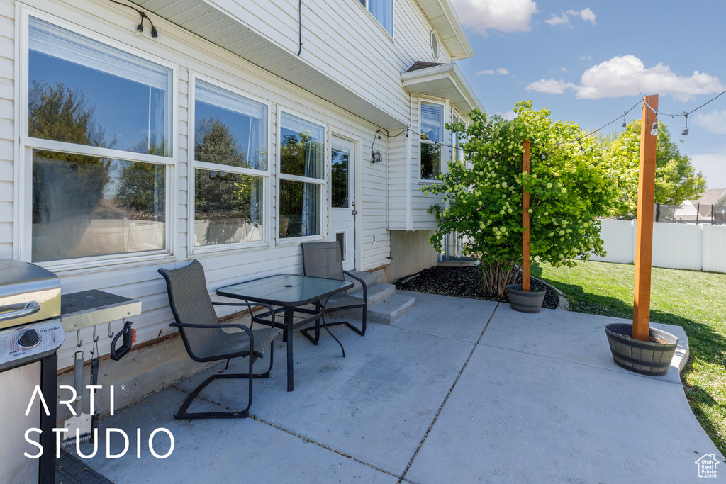 View of patio featuring fence