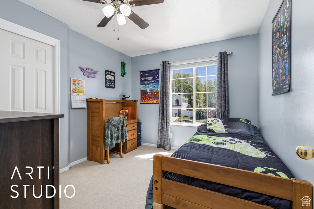 Carpeted bedroom featuring baseboards and a ceiling fan
