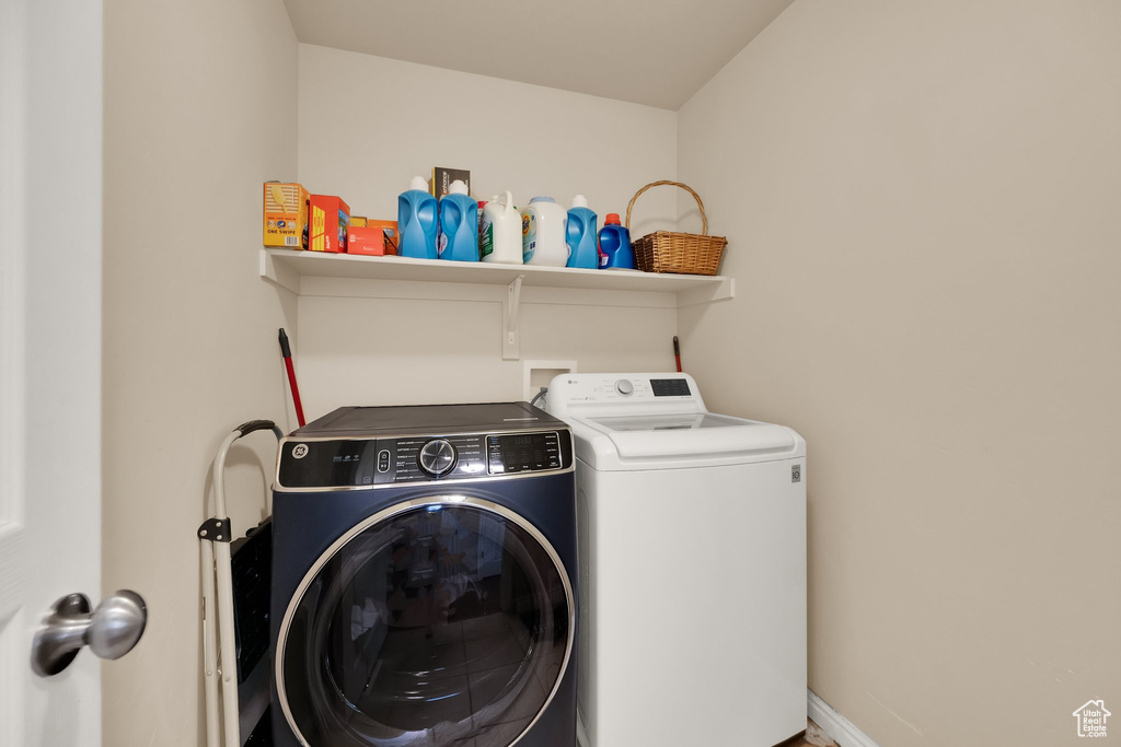 Washroom featuring laundry area and separate washer and dryer
