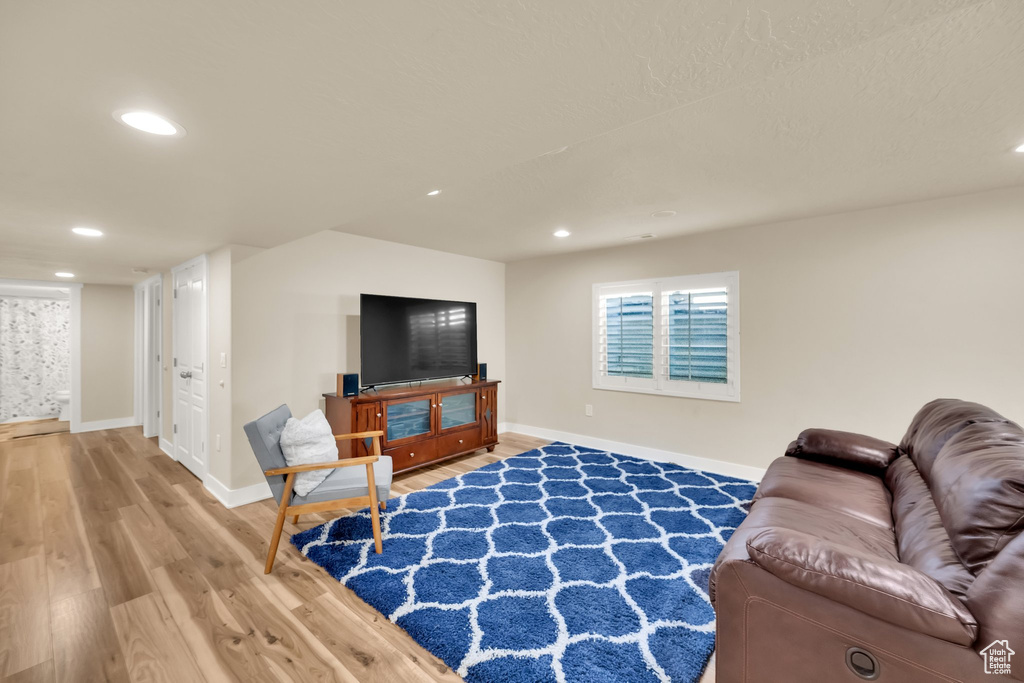Living room with baseboards, recessed lighting, and wood finished floors
