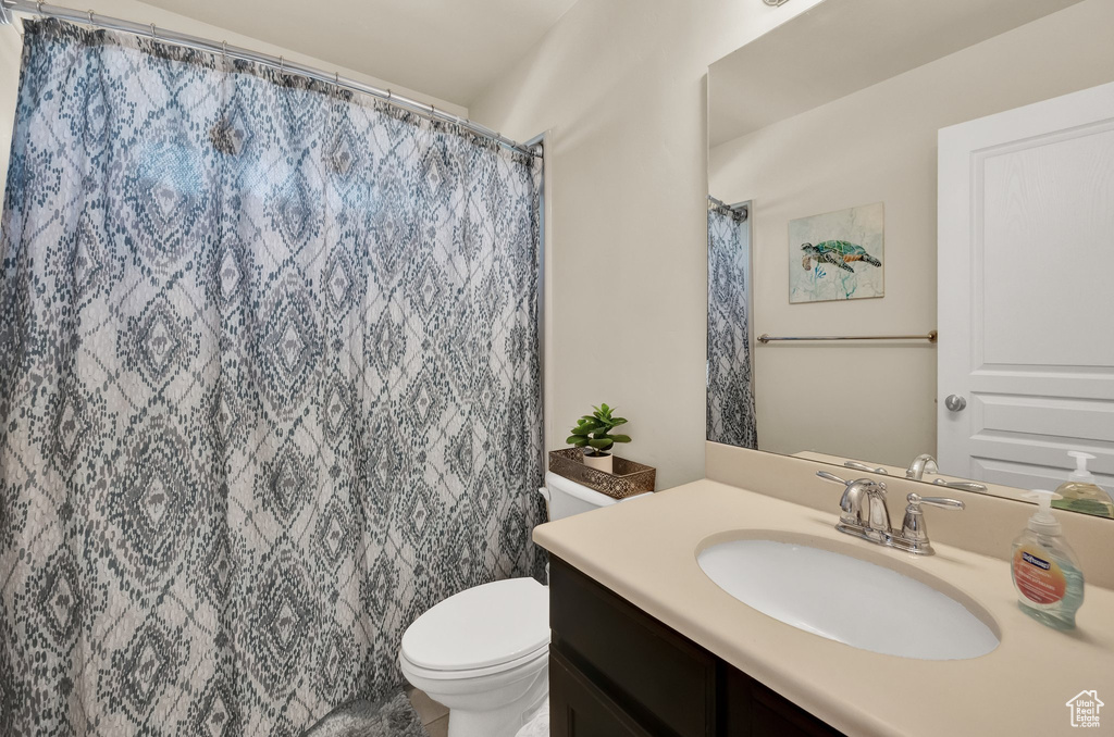 Full bathroom featuring toilet and vanity