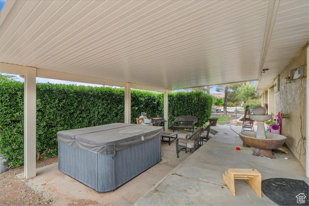 View of patio / terrace with a hot tub