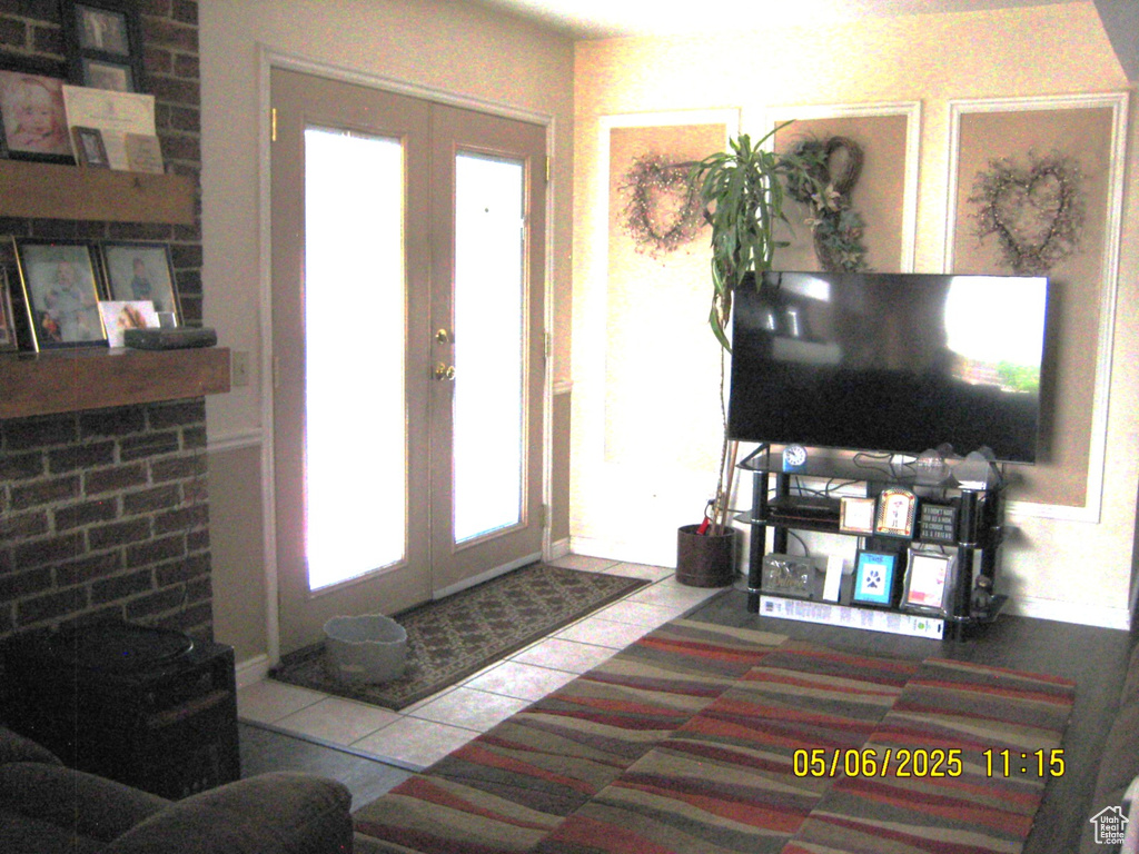 Tiled entryway with french doors and plenty of natural light