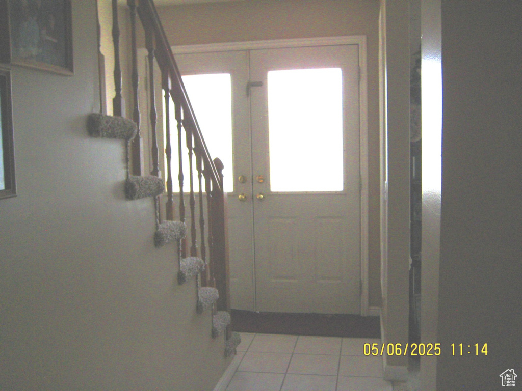 Entryway featuring stairway and tile patterned floors