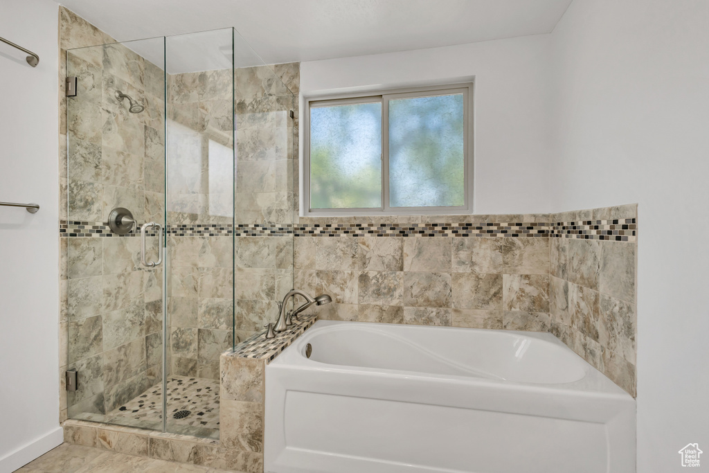 Full bathroom with a garden tub and a shower stall