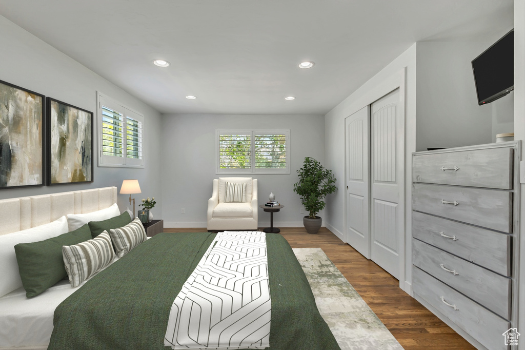 Bedroom featuring a closet, dark wood finished floors, baseboards, and recessed lighting