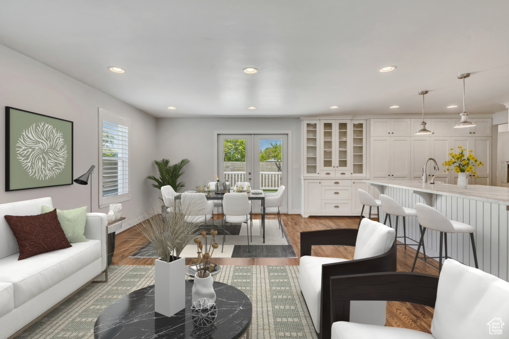 Living area featuring a healthy amount of sunlight, recessed lighting, and wood finished floors