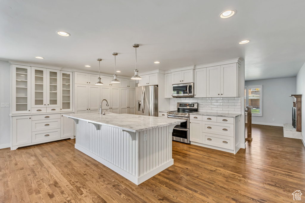 Kitchen featuring white cabinetry, recessed lighting, a kitchen island with sink, and appliances with stainless steel finishes