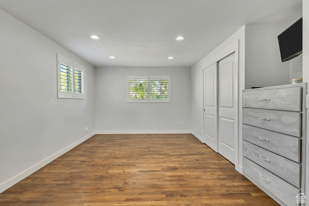 Unfurnished bedroom with dark wood finished floors, baseboards, and recessed lighting