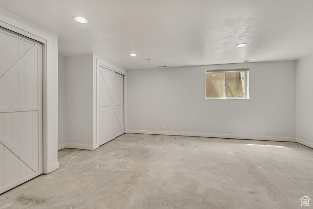 Basement with baseboards and recessed lighting
