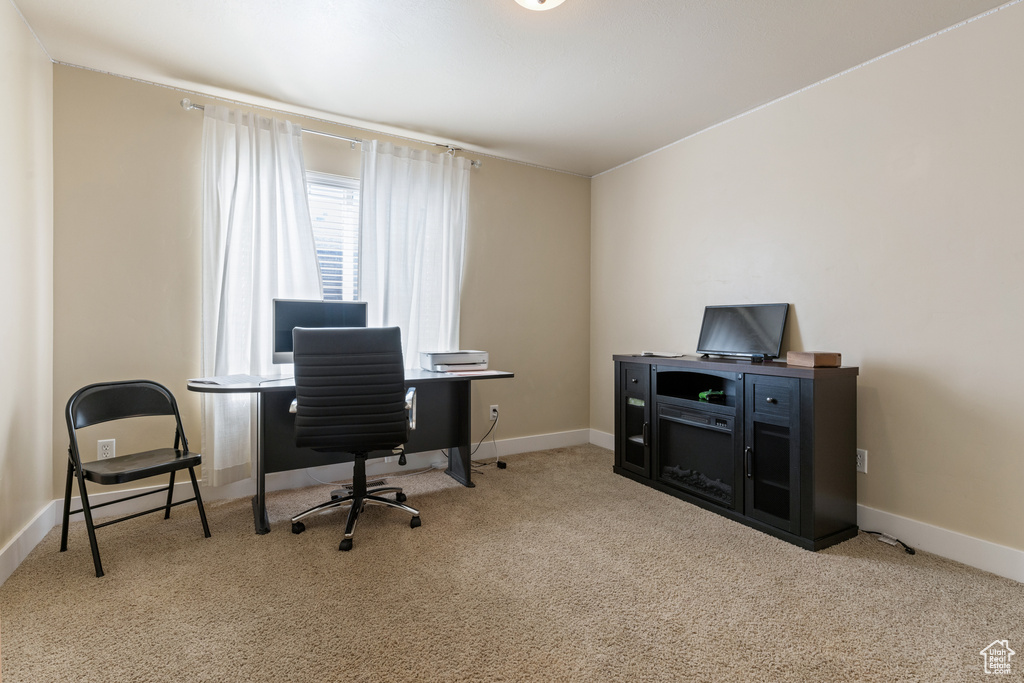 Carpeted office space with baseboards