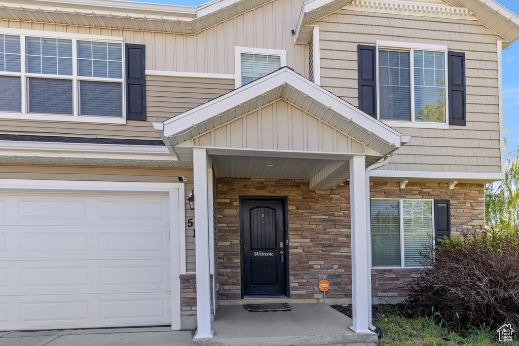Entrance to property featuring stone siding