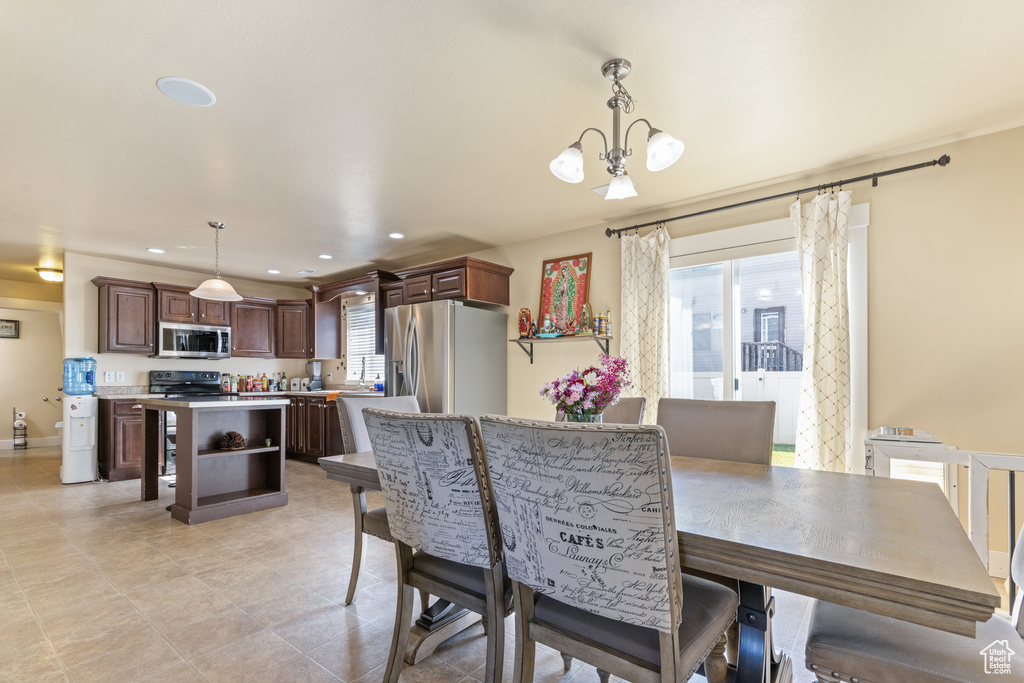 Dining space featuring recessed lighting, light tile patterned flooring, and a notable chandelier