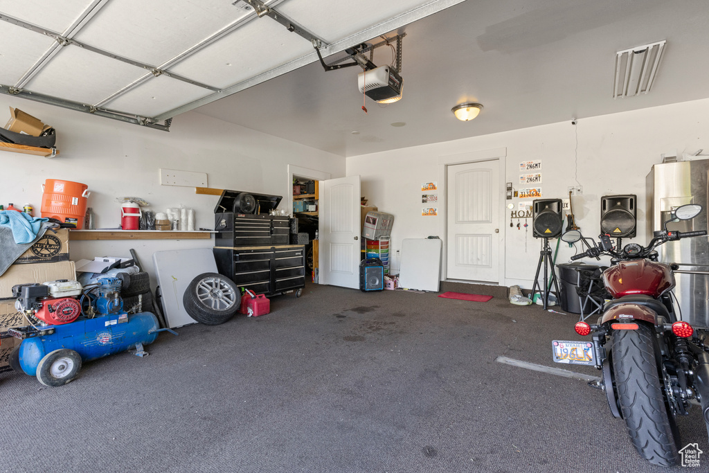 Garage featuring a garage door opener