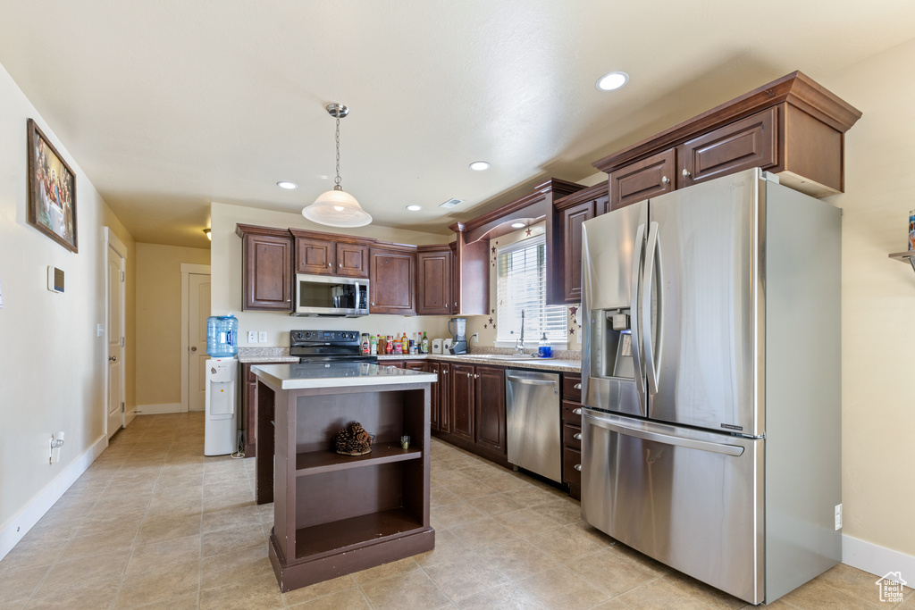 Kitchen with stainless steel appliances, recessed lighting, a center island, open shelves, and light countertops