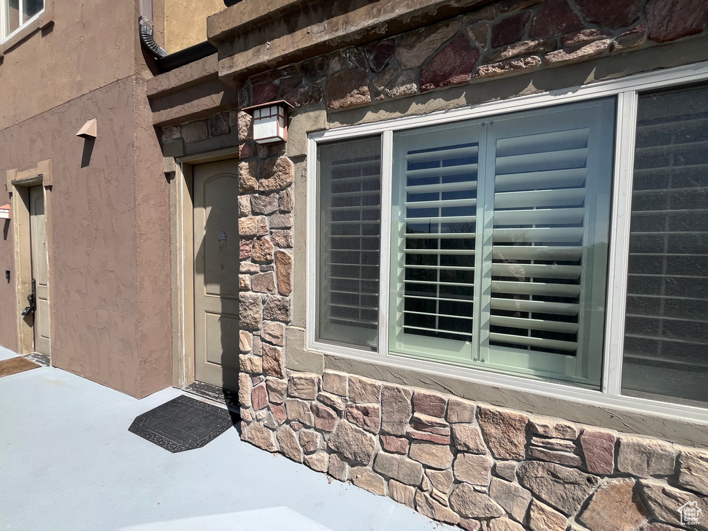 Entrance to property with stone siding
