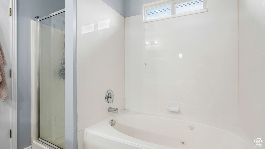 Full bathroom with a shower with shower door and a bathtub