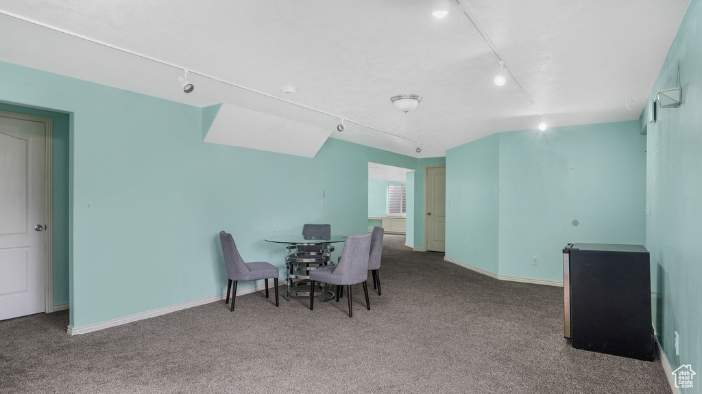 Dining room featuring baseboards, carpet, and track lighting